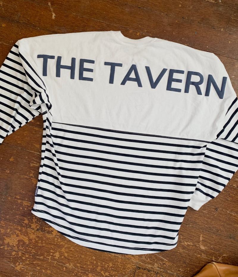 Sweatshirt? Longsleeve shirt? Both? Whatever you call it, it is the most comfortable shirt we’ve worn! The perfect weight for cool nights, The Tavern Spirit Jersey is a great all season piece and a new wardrobe staple.  Details & Care: Navy and White. 100% preshrunk cotton. Machine wash and tumble dry low or air dry.  Fit: Dropped shoulders, banded neckline and curved hem. Looks good on everyone with a roomy fit.